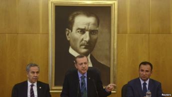 Turkish Prime Minister Recep Tayyip Erdogan (center), accompanied by deputies Bulent Arinc (left) and Bekir Bozdag, speaks during a news conference at Ataturk International Airport in Istanbul on June 3.
